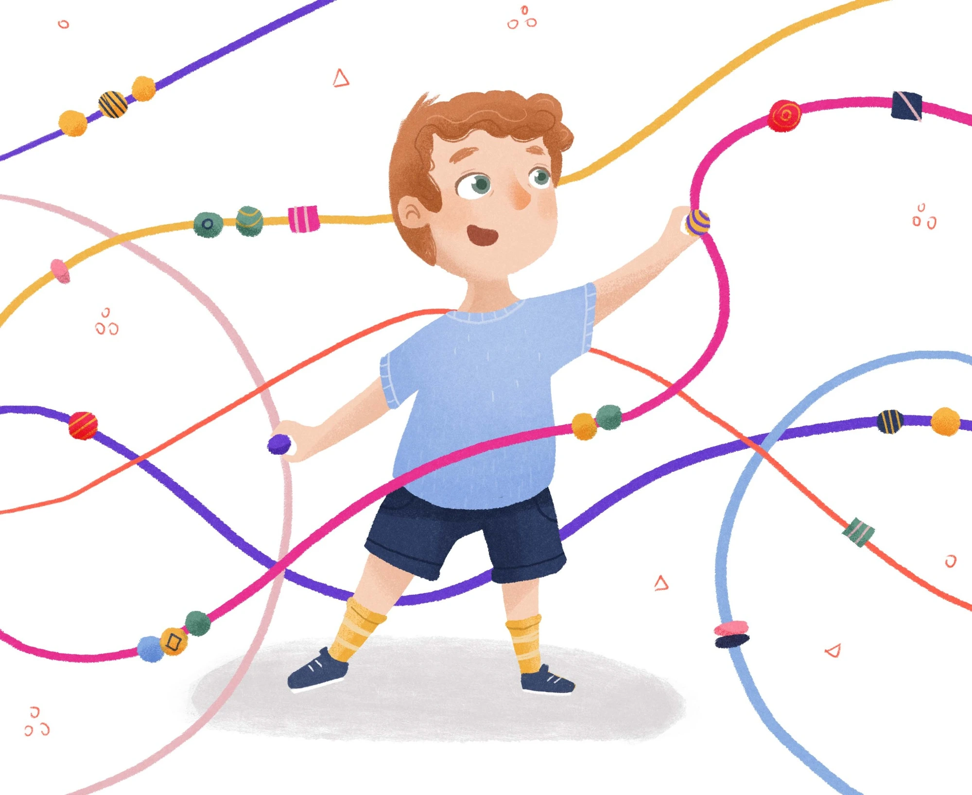 Smiling child playing among colorful looping strings and patterned beads