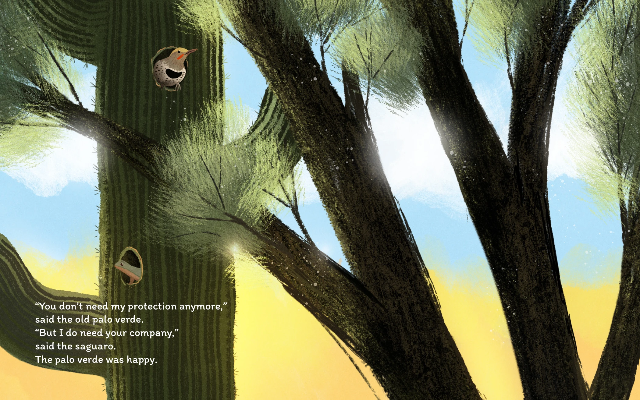 Close view of a mature saguaro and the palo verde with a bird at its nest